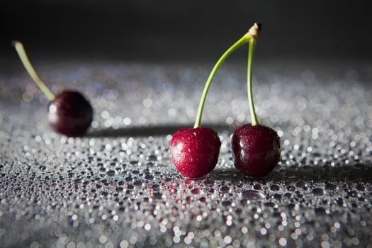 Wet sweet cherry with water droplets.