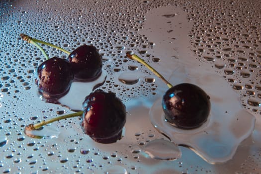 Wet sweet cherry with water droplets.