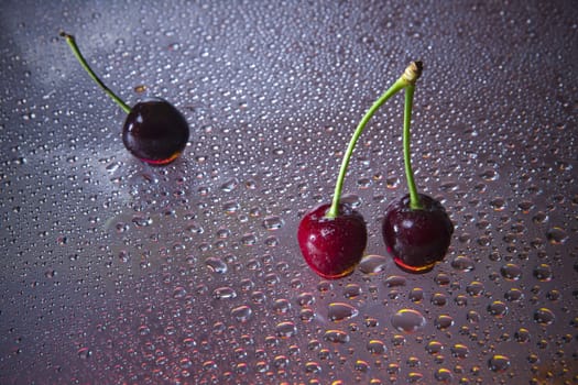 Wet sweet cherry with water droplets.
