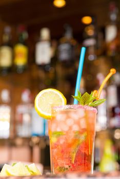 Freshly prepared strawberry mojito against the backround of a bar