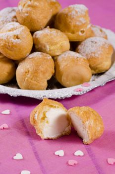 Heap of freshly made profiteroles on a dessert plate