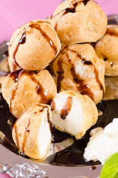 Closeup take of freshly made profiteroles with chocolate