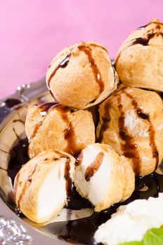 Closeup take of freshly made profiteroles with chocolate