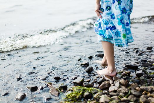 Girl walking in shallow water in a lake