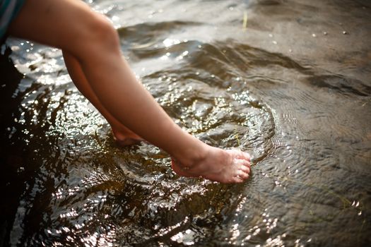 Toes dipping in water on a warm summer day