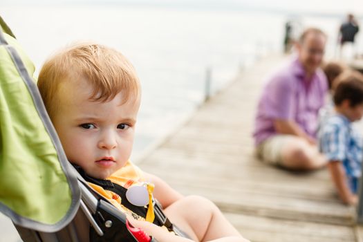 Baby in a stroller by a wharf