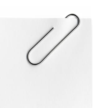 Scanned metal paper clip and paper on white background.