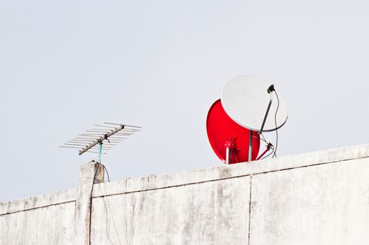 Satellite dish antenna over blue sky background