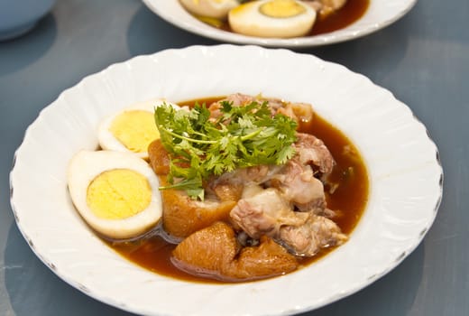 Stewed pork leg served with eggs, Thai cuisine