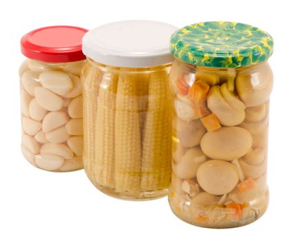 garlics corns champignon mushrooms canned preserved marinated in glass pots jars isolated on white. ecological organic food resource for winter.