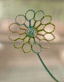 Background from multi-colored braiding with a flower in the center