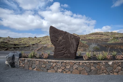 stone monument surrounded by aloe vera