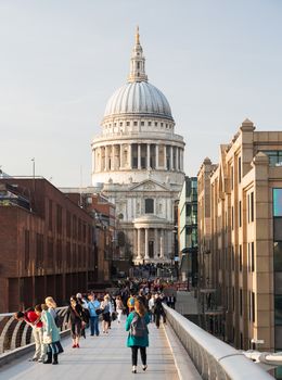 LONDON, UK - 23 APRIL: Londoners walk home from St Pauls cathedral area of London on 23 April 2013. The dome at 365 feet high towers over Millenium Bridge