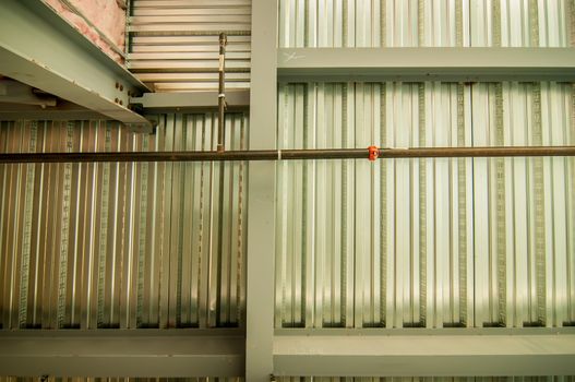 exposed underside of steel floor or roof deck with utilities and spray-on fireproofing