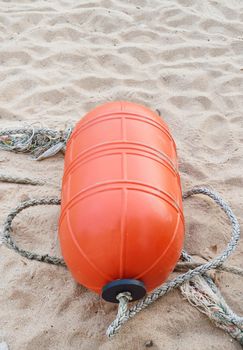 Orange buoy on the beach