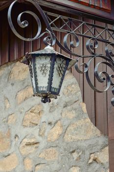 An old street lamp on a stone wall