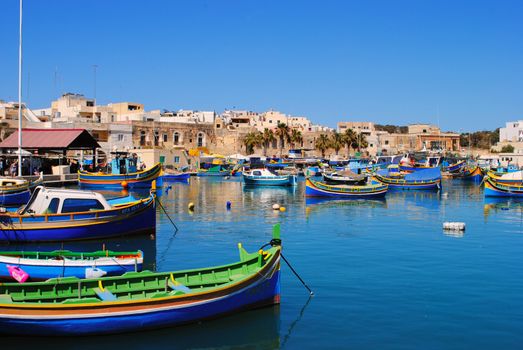 Traditional fishing boats in the maltese village of Marsaxlokk, located in the south-eastern part of Malta, with a population of 3,277 people.