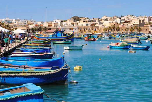 The waterfront of Marsaxlokk, a traditional fishing village located in the south-eastern part of Malta, with a population of 3,277 people.