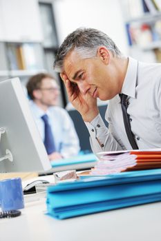 Businessman under stress, fatigue and headache