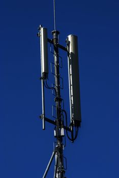 Mobile phone service antenna on blue sky background