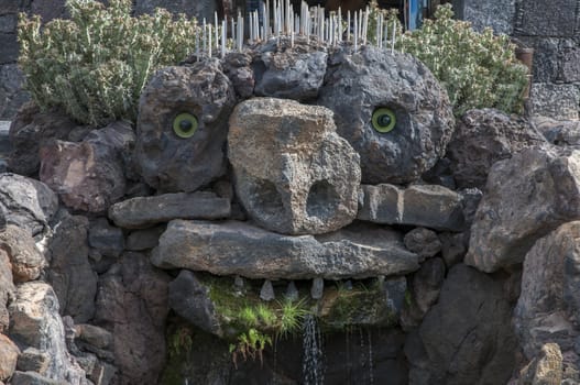 Memorial stone faced spewing water