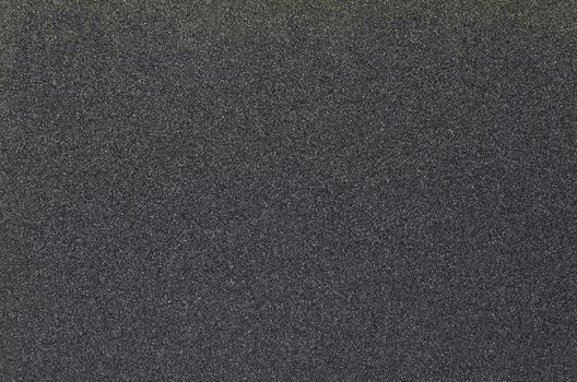 Sandpaper texture, black abstract grain background