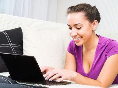 Portrait of an attractive young woman using laptop at home