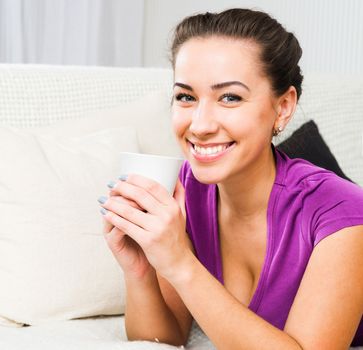 Young beautiful girl with tea cup in room