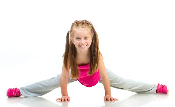 young girl doing gymnastics over white background