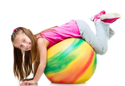 Little girl doing gymnastics with ball over white background