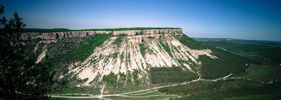 green hill with a road around