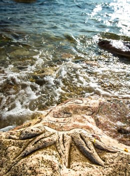 Rock carvings on the beach (octopus) near Sevastopol (Crimea), Ukraine, May 2013