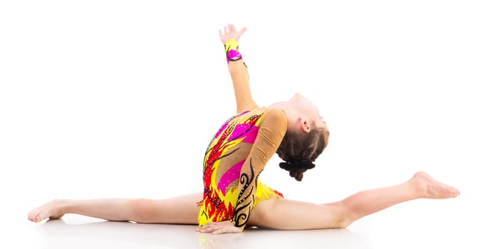 little girl gymnast on the splits with hand up on a white background