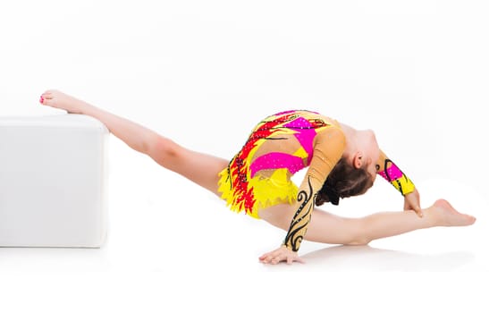 little girl gymnast on the splits over white background