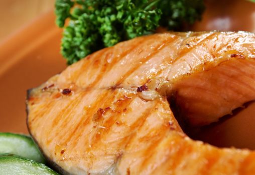 delicious grilled salmon steak with vegetables . Shallow depth-of-field