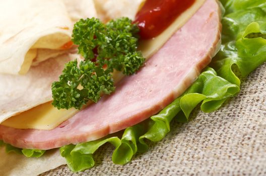 Pita Sandwich with cheese,ham,parsley,and tomato sauce