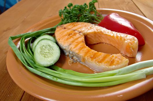 delicious grilled salmon steak with vegetables .closeup