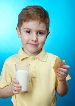  little boy  eats homemade pie and glass of milk