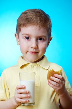  little boy  eats homemade pie and glass of milk