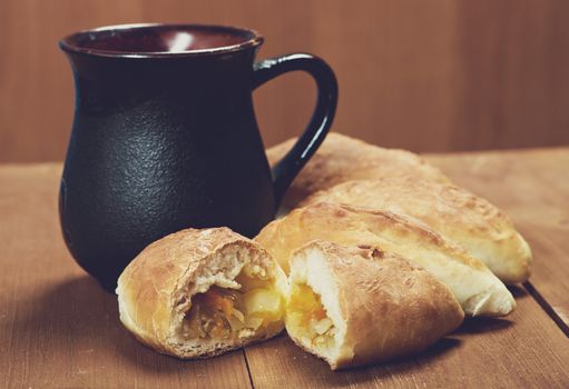 russia traditions pierogi .Home cake with cabbage against the wooden table