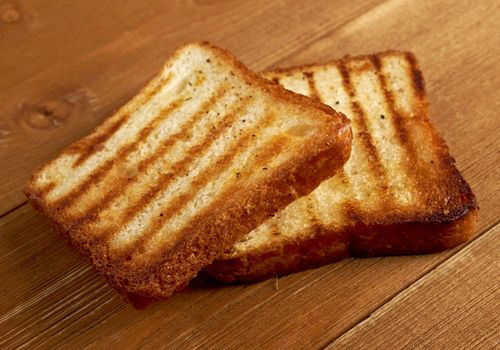 pile  toasted bread slices for breakfast.Close up of toasted white bread in slices