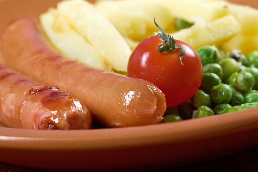 Sausages with french fries and vegetables