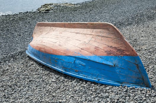 boat on the beach of colors upside down