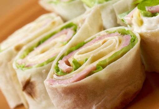 healthy club sandwich pita bread roll with cheese,ham,parsley