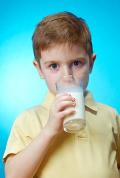  little boy  eats homemade pie and glass of milk