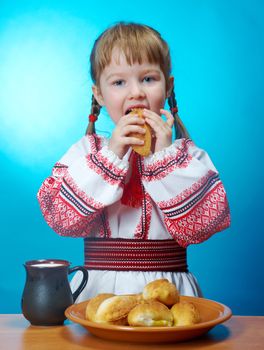 Russian little girl eats homemade pie