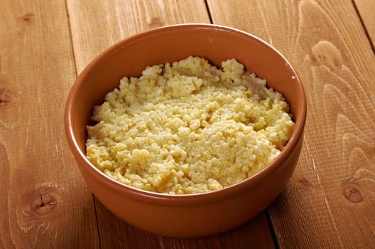 Millet porridge in brown bowl on table