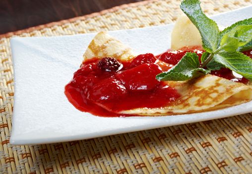 Pancakes with strawberry jam.closeup