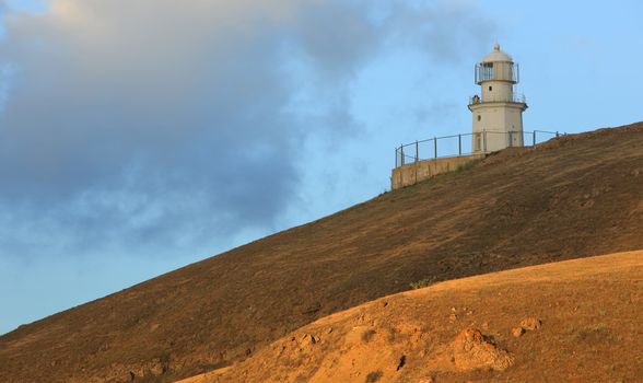 Lighthouse. The movement of clouds on the mountain Meganom, Crimea, Ukraine