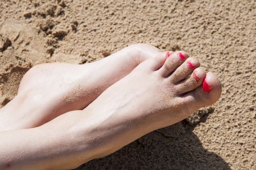feet relaxed on the beach sunbathing